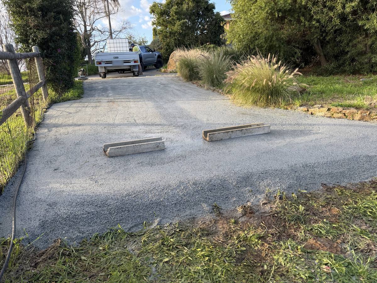 Crushed rock driveway with concrete drainage channels