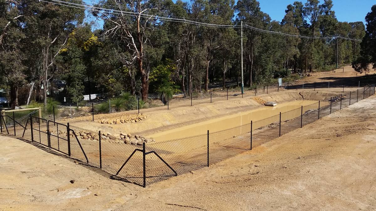 Black chainmesh fencing and double gates on a subdivision